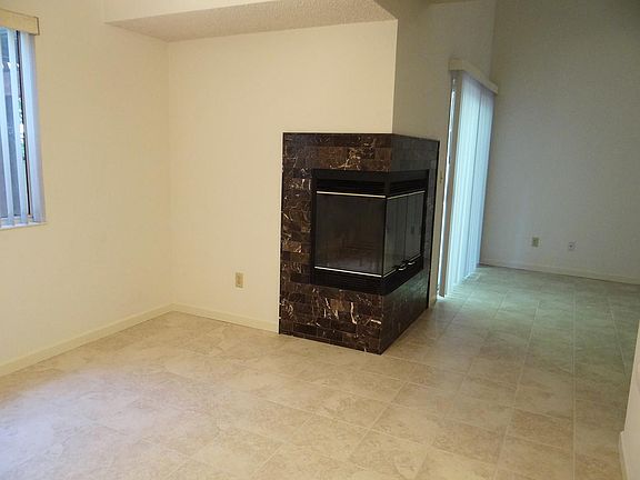 Corner fireplace from dining area to living room.