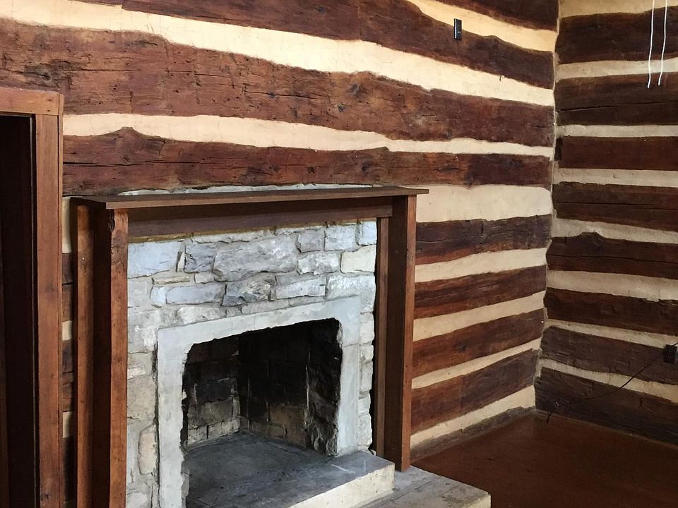 Beautiful hand hewn logs dating to circa 1832 - all walls in great room. Vaulted ceiling with ceiling fan. Original stone fireplace (disabled/non working). Original hardwood floor.