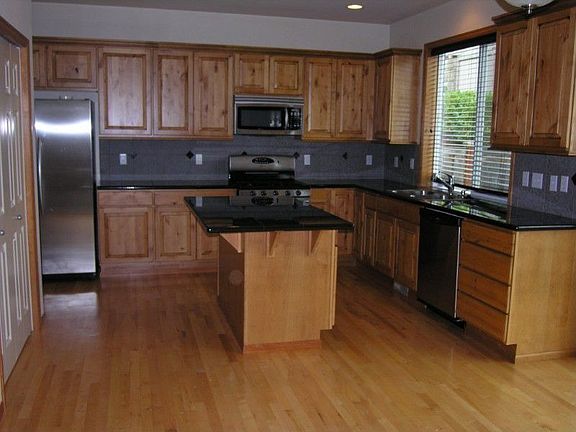 Kitchen w/island, granite counter tops, maple cabinets and stainless steel appliances.
