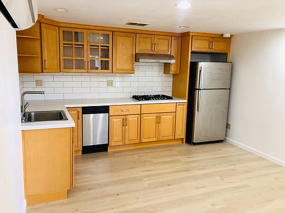 This newly renovated kitchen has brand new shelving and gas range.