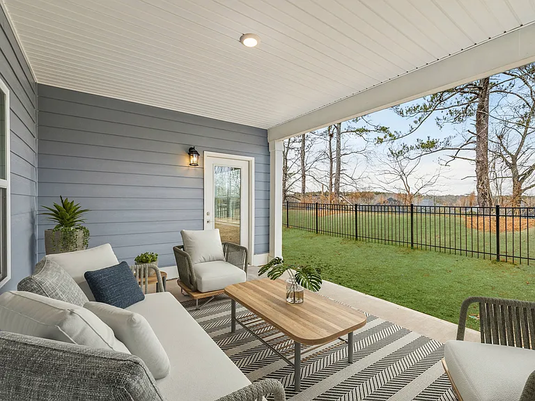 Private covered patio overlooking a fenced backyard.