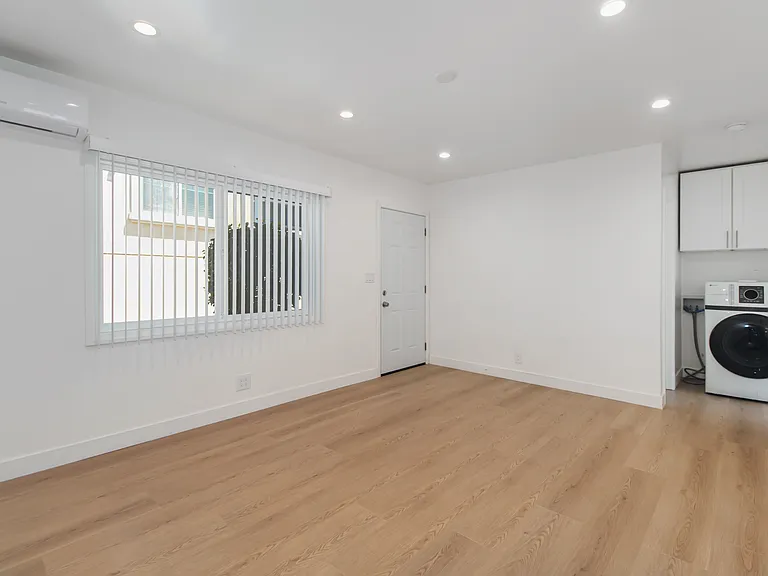 Living Room leading to Bedroom & Bathroom with in unit Washer & Dryer