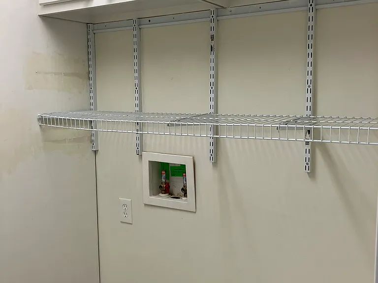 Laundry Room with washer-dryer hookups and cabinets.