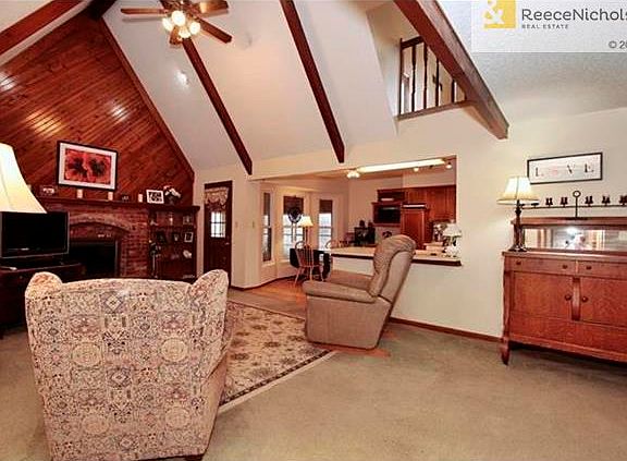 Great room has open concept with the tall vaulted ceiling and breakfast bar to the kitchen.