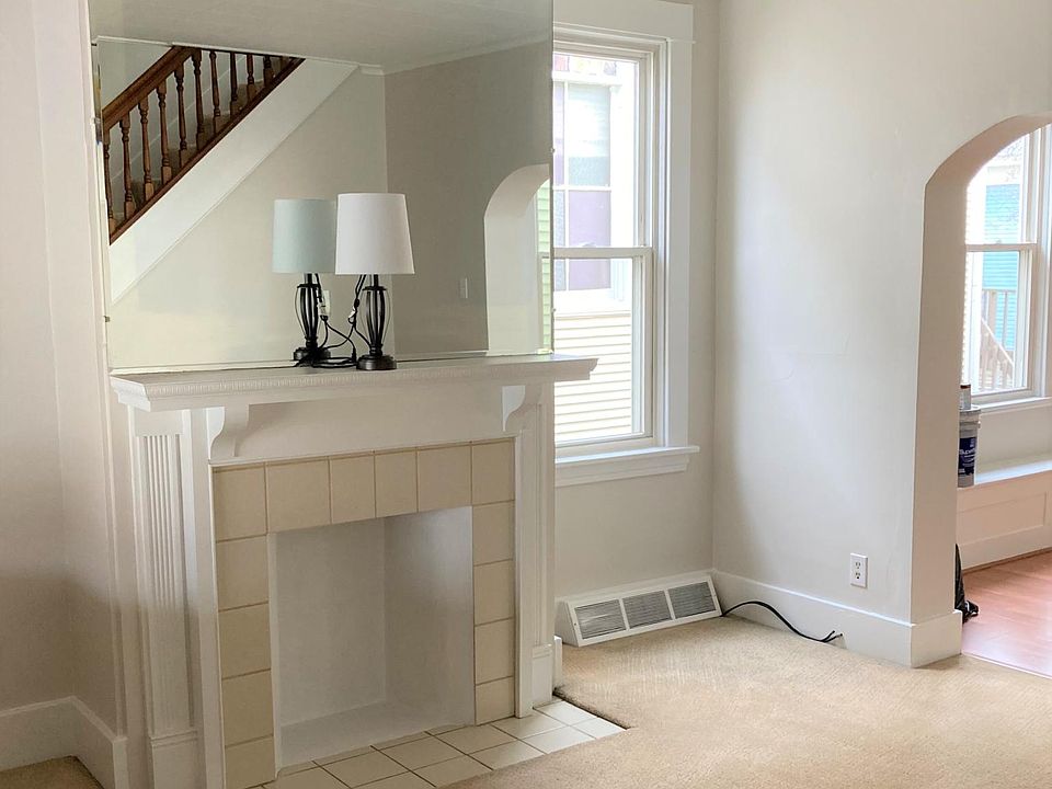 Bright but cozy living room with antique mirror and fireplace mantle (fireplace is not real so no heat loss)