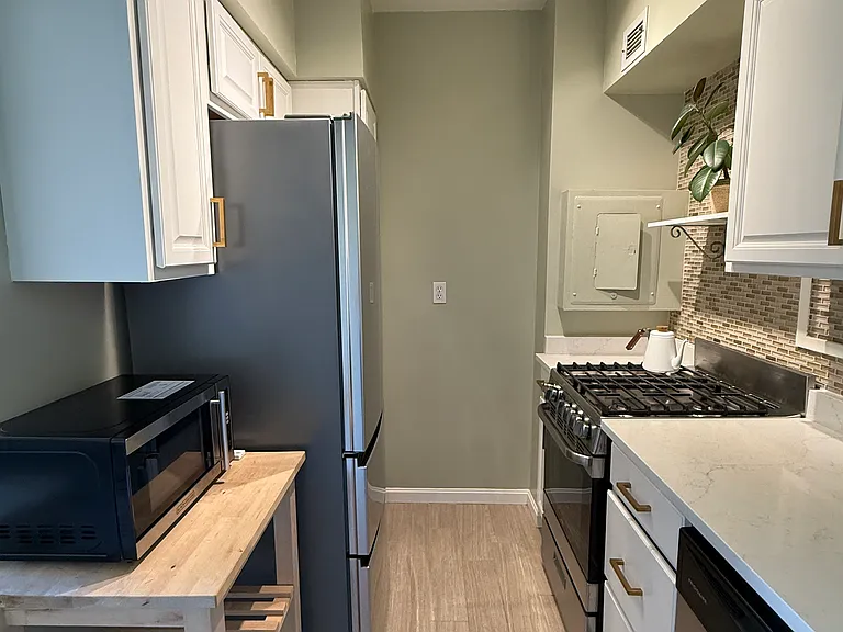 Lots of cabinet space and quartz countertops.