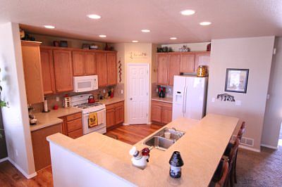 Large kitchen with pantry, gas range/oven and upgraded lighting.