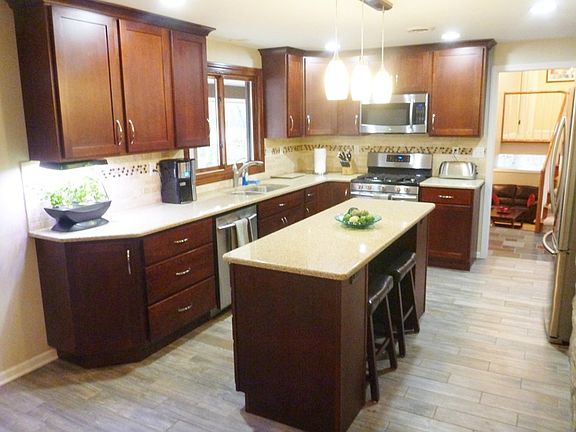 Absolutely Stunning Renovated Kitchen with Quartz Countertops, Custom Cherry Cabinets and Stainless Steel Appliances was designed by Julie Ratcliffe and has been featured in her portfolio