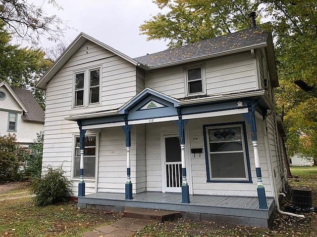 Front of house with porch and newly painted columns