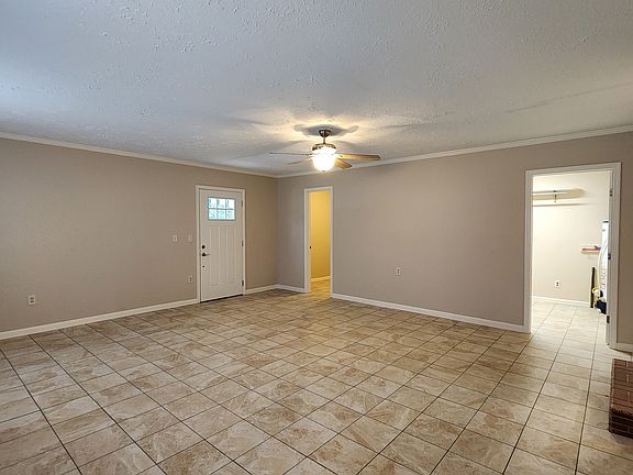 Den with view of laundry room and storage room