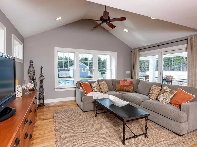 Living room with view out to pool and patio.