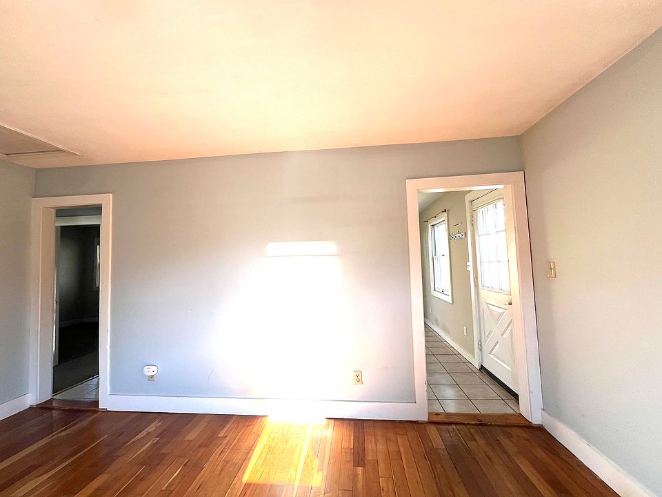 Living room looking into kitchen on the right and down the hall towards bedrooms and bathroom on the left.