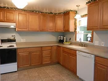 Neat & clean kitchen offers newer cabinets & solid surface countertops