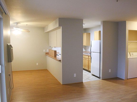 Main living with views into the dining room, kitchen, and hallway.