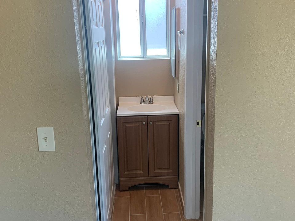 Master bedroom with the sink outof walk in shower. The commode and sink are new.