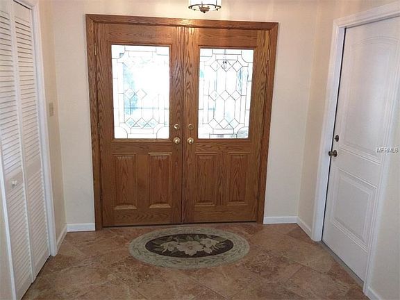 Beautiful Tiled Foyer entry;Offers storage closet and the Garage access door.