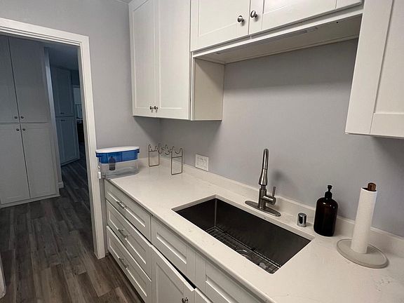 Kitchen with new deep stainless steel sink, garbage disposal, dishwasher, and new quartz counters.