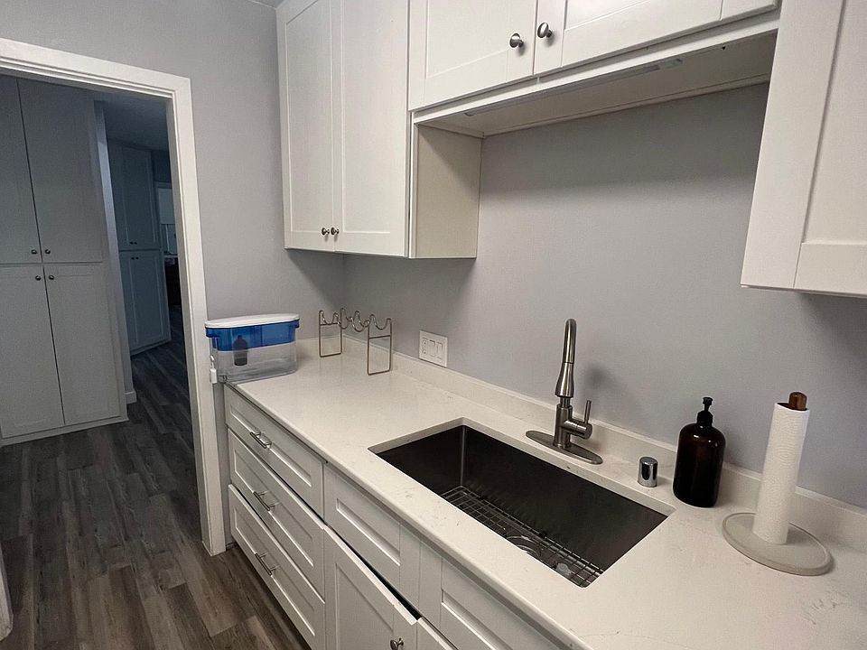 Kitchen with new deep stainless steel sink, garbage disposal, dishwasher, and new quartz counters.