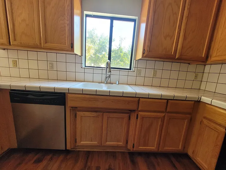 The kitchen has NEW White Granite, and cabinets have been painted White.