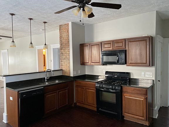 Open concept kitchen with granite counter tops and all full sized appliances