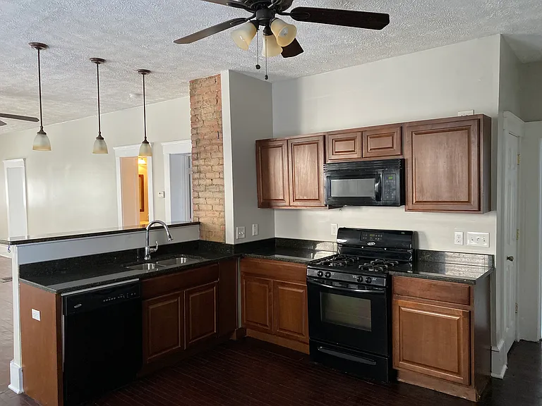 Open concept kitchen with granite counter tops and all full sized appliances