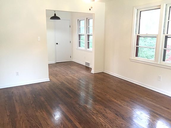 From living room looking into dining room and door to basement