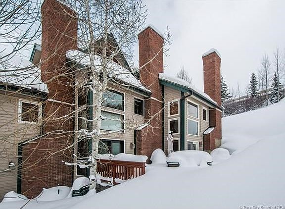 This is the deck behind the aspen tree..covered in our POWDER! Approved for your private hot tub, if you desire.