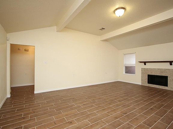 Spacious living room. Doorway to the left leads to the bedrooms and bathrooms.