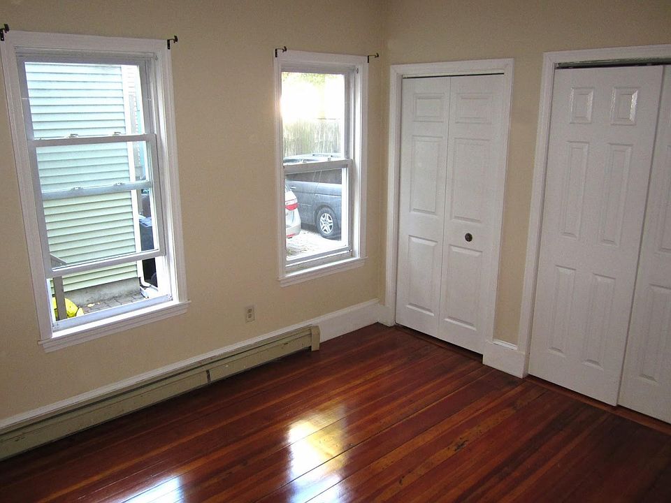 1 of the 3 bedrooms with 2 closets and hardwood floors