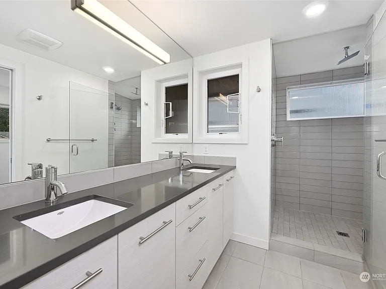 Master bathroom with dual vanity, private toilet room and double shower head