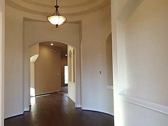 Beautiful rotunda entry w/ 5" hand scraped wood floors.