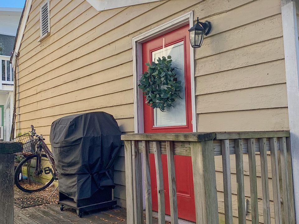 One enters the apartment off of a shared deck that is located between the front and back building on the property.