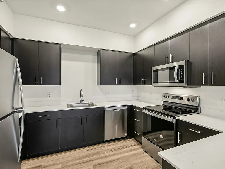 A huge chef's kitchen with ample storage and high-end appliances. A huge chef's kitchen with ample storage and high-end appliances.