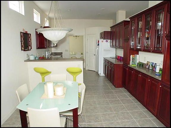 Breakfast room includes butler's pantry with glass-fronted cherry cabinets