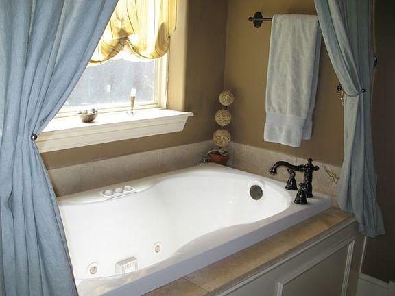 Whirlpool tub and travertine tile in master bathroom