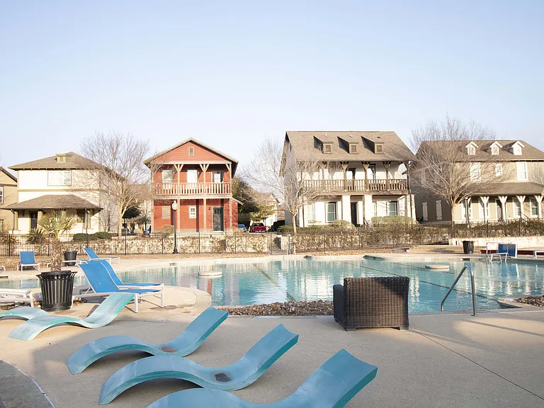 Relax and unwind at this picturesque community pool, surrounded by charming homes.