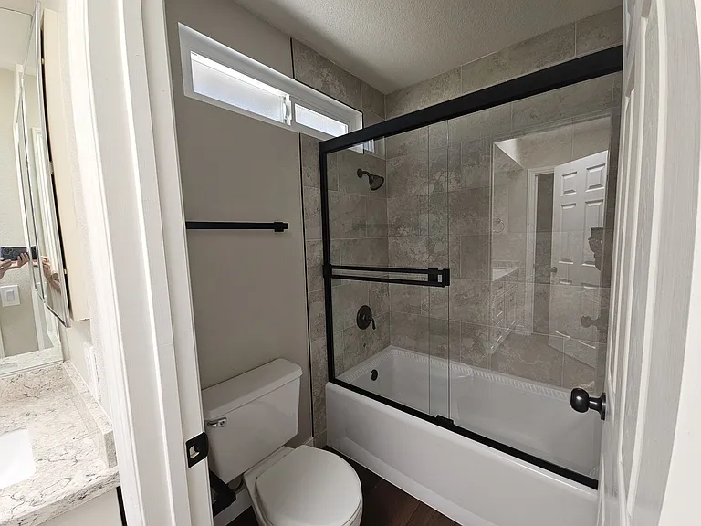 Newly retiled with shower doors