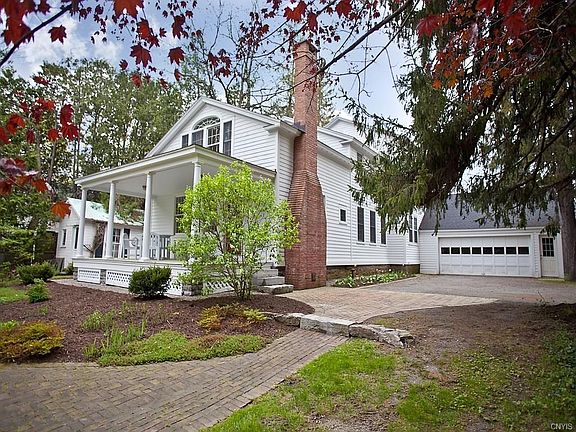 Rear of home showing back porch off kitchen and entrance to garage