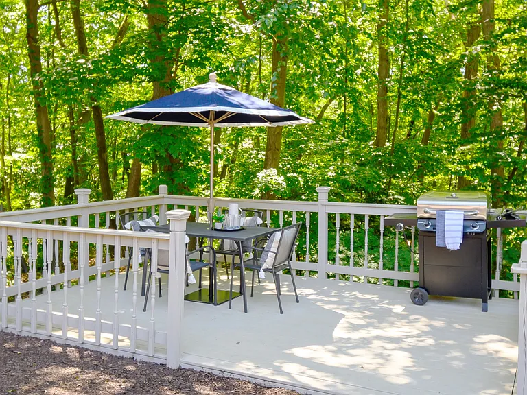 Enjoy Outdoor Dining and Grilling Surrounded by Serene Woodland Beauty.