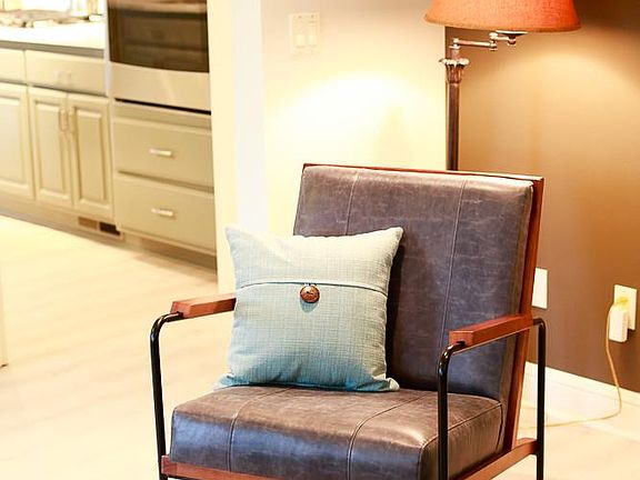 Comfy and tasteful seating options. Warm accent colors.