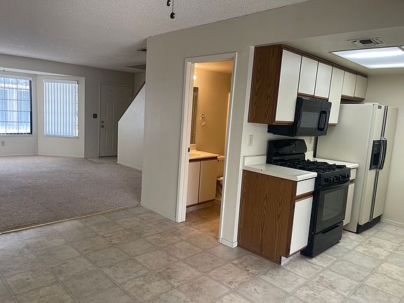 Full bath downstairs with galley kitchen and eating area close to front room and door.