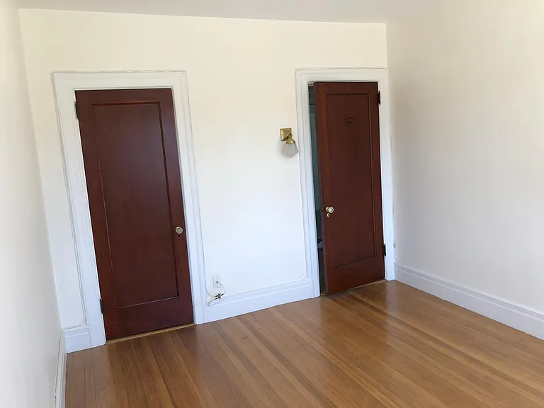 bedroom 2. Closet and entry door.