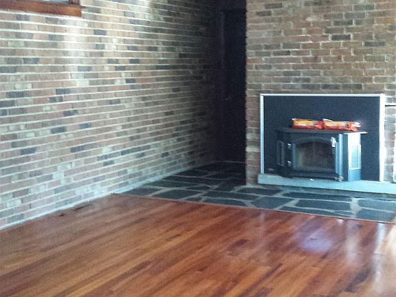 Living Room with fire burning fire place, hard wood floors a
