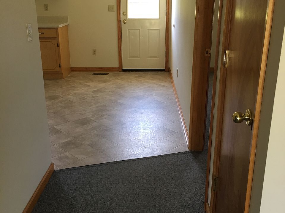 Hallway with coat closet and entrance to back bedroom and dining area, plus back door to patio.