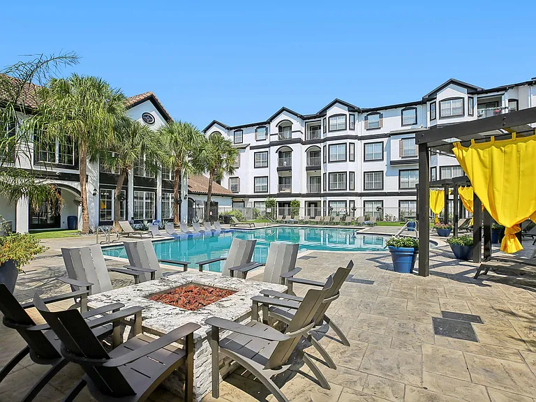 Residents enjoy relaxing evenings around the outdoor fire pit at Providence Uptown in Houston.