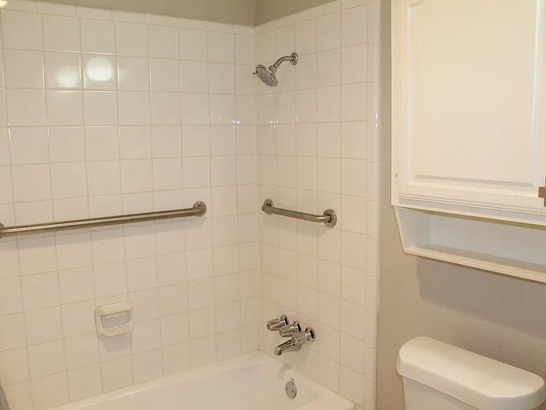 Tub and shower combination with built-in safety grabs for added support