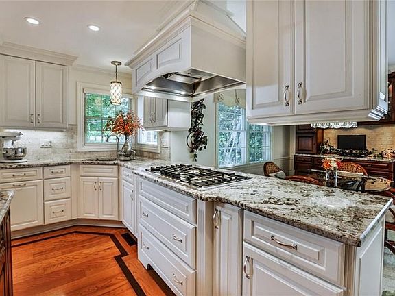 The kitchen is further enhanced with beautiful granite counter tops, high-end appliances and Schuller cabinetry.