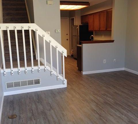 Beautiful new flooring.View from living room into kitchen and upstairs.