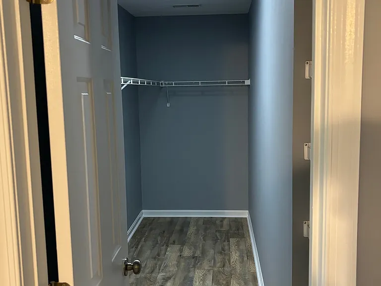 Walk-in closet. Storage shelves in the alcove barely visible on the right side of the pic.