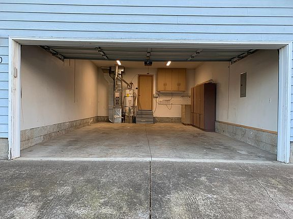 Deep 2 car garage with cabinets and work bench.